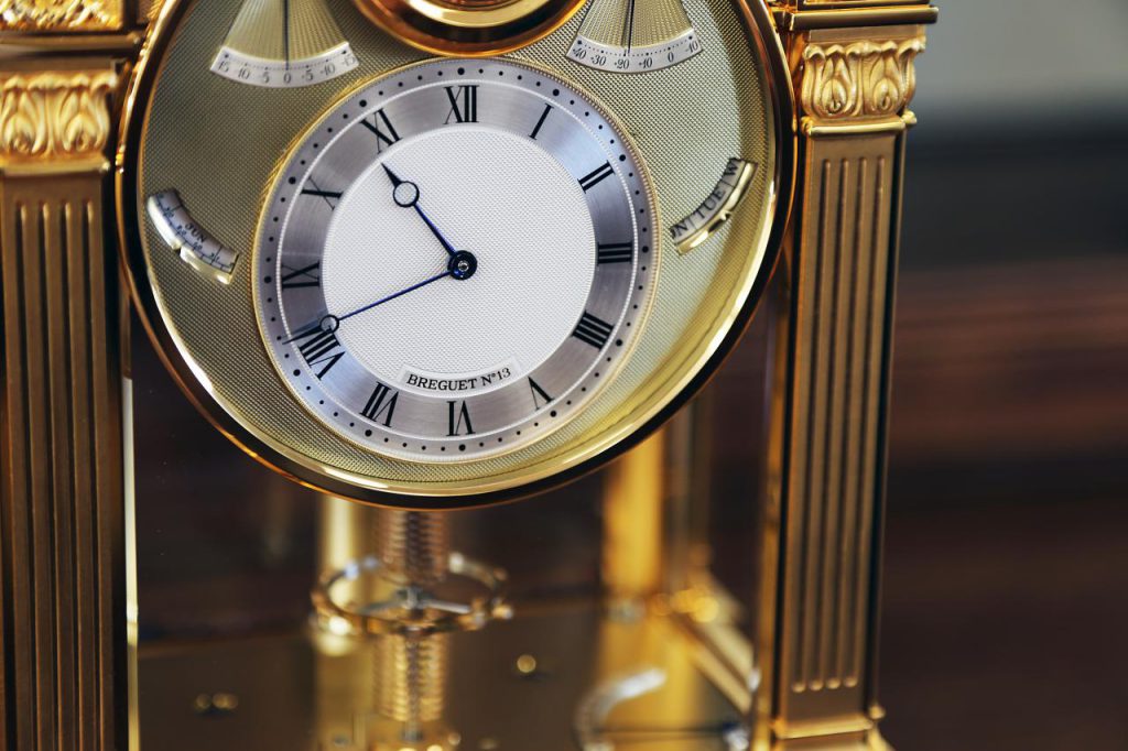 The clock has the unmistakable hallmarks of a Breguet timekeeper, from its engine-turned silver dial to its Roman numerals and blued-steel apple hands.